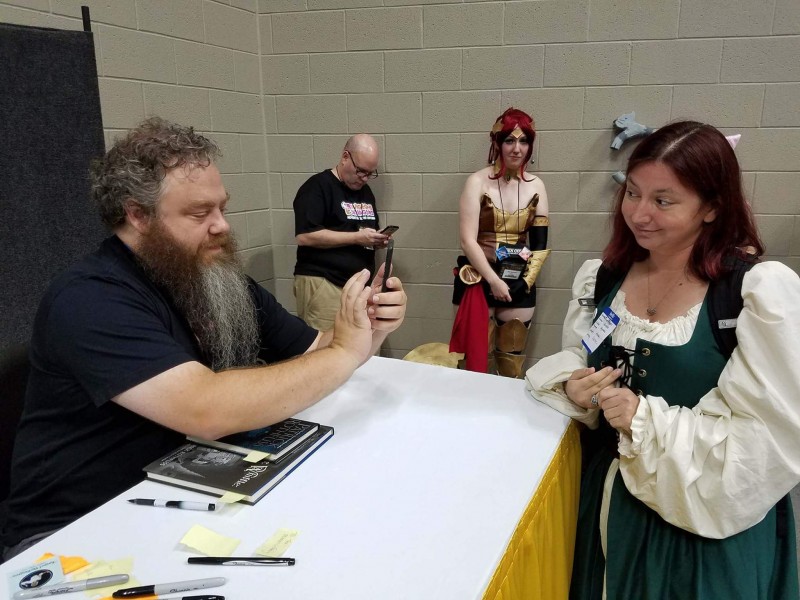 Patrick Rothfuss taking a picture of my Denna costume with his cellphone.