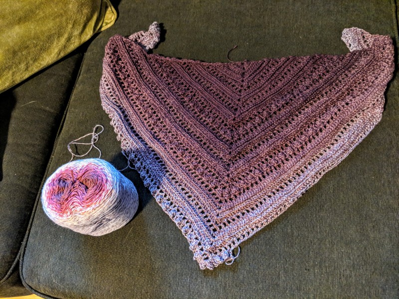 A shawl in different shades of purple.