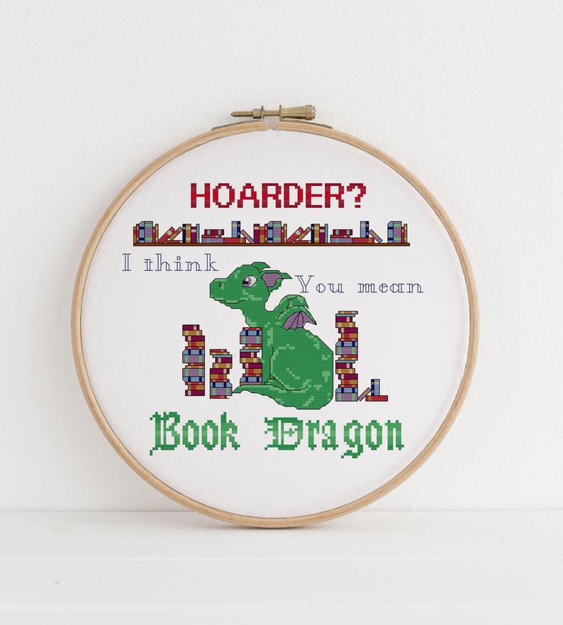 Cross-stitch pattern with the text 'Hoarder? I think you mean Book Dragon' on it.