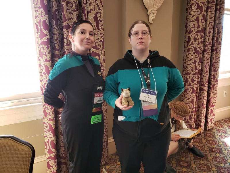 My friend Kasi and I, both wearing Starfleet science officer uniforms, with trill spot makeup on.