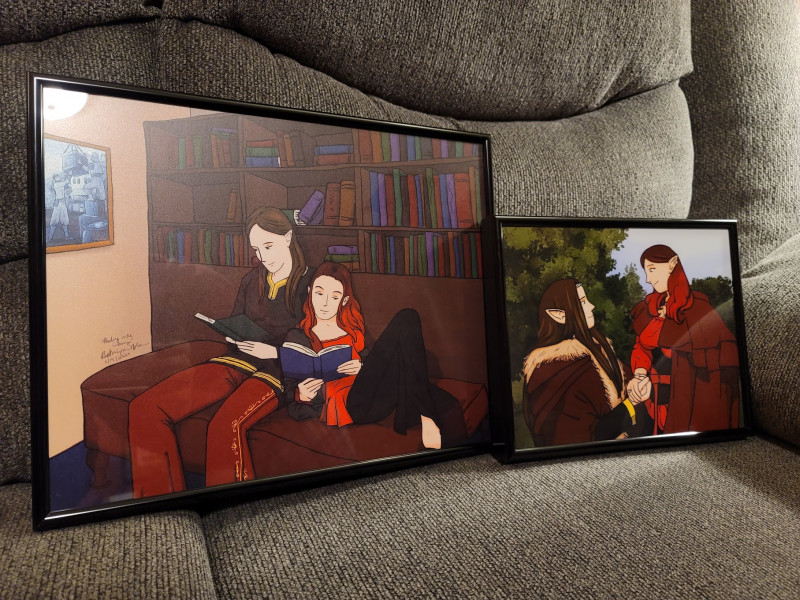 Photograph of two digitalframed sketches of Elinyr and Alair.