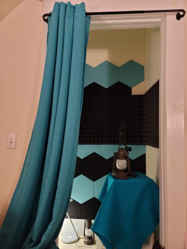 View through the doorway into my soundbooth - black and teal felt tiles are visible on the walls.
