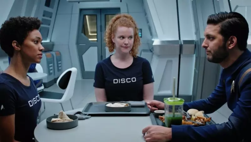 Tilly wearing a navy blue t-shirt that says DISCO on the front.