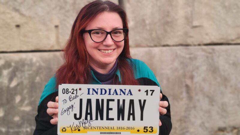 Me holding my autographed Janeway license plate.