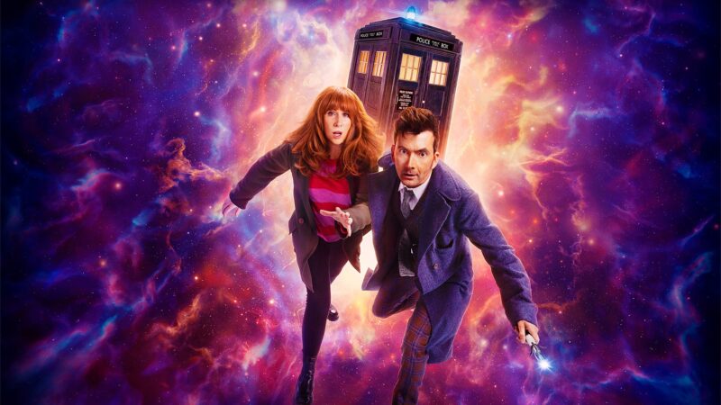 Donna and the Fourteenth Doctor in front of the TARDIS, over a nebulous purple, blue, and orange background.